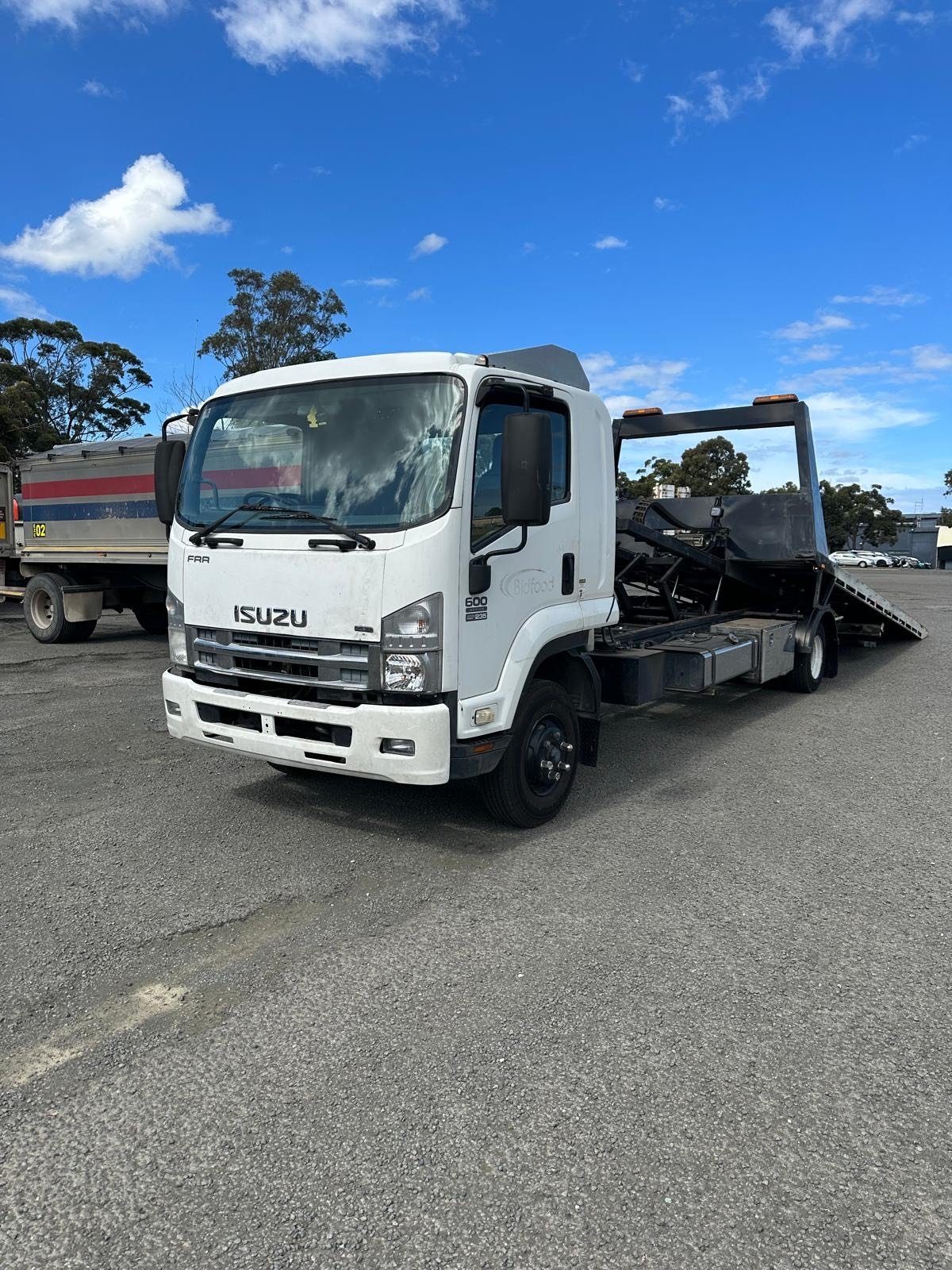 Billy's white Isuzu tilt tray tow truck parked in Sydney